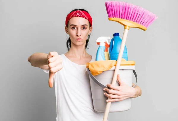 Young Pretty Woman Feeling Cross Showing Thumbs Housekeeper Concept — Stok fotoğraf