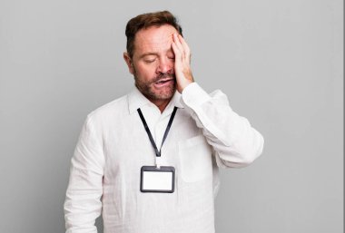 middle age man feeling bored, frustrated and sleepy after a tiresome. vip pass id accreditation