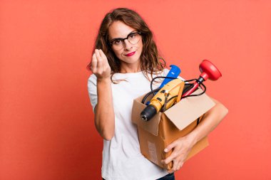 hispanic pretty woman making capice or money gesture, telling you to pay with a tool box. handyman concept