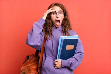 hispanic pretty woman looking happy, astonished and surprised. university student concept