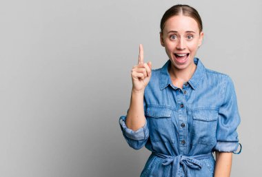 caucasian pretty woman feeling like a happy and excited genius after realizing an idea