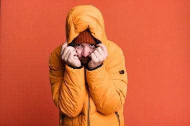 Uzun sakallı, kızıl saçlı, şapkalı ve ceketli havalı bir adam. Soğuk ve kış kavramı