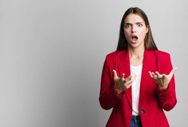 young pretty woman feeling extremely shocked and surprised. businesswoman concept