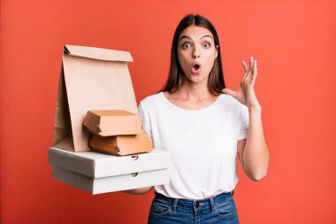 young pretty woman screaming with hands up in the air. delivery and take away concept