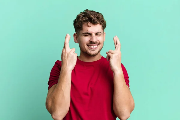 Young Adult Caucasian Man Smiling Anxiously Crossing Both Fingers Feeling — Stok fotoğraf