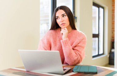 pretty young woman with a laptop on a desk  at home