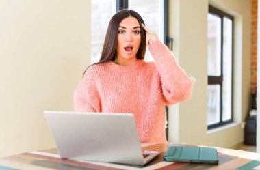 pretty young woman with a laptop on a desk  at home