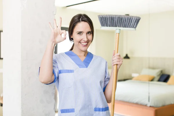 Young Pretty Woman Feeling Happy Showing Approval Okay Gesture Housekeeper — Stockfoto