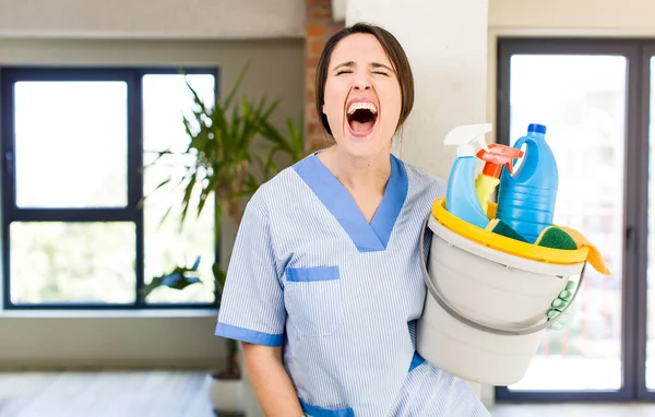 Young Pretty Woman Shouting Aggressively Looking Very Angry Housekeeper Concept — стоковое фото