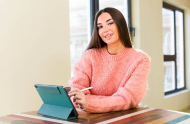 young pretty woman using a touchscreen pad at home