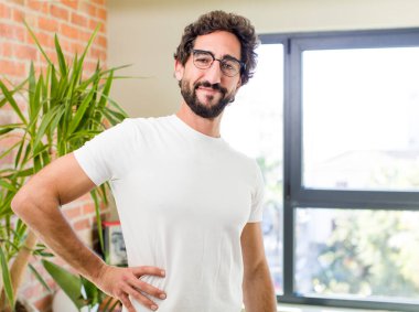 young adult crazy man with expressive pose at a modern house interior