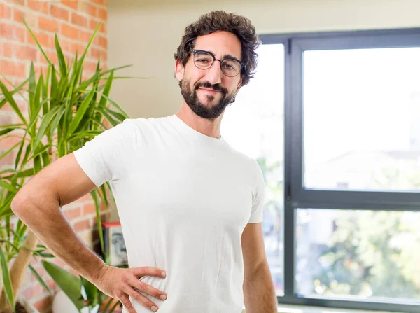 young adult crazy man with expressive pose at a modern house interior