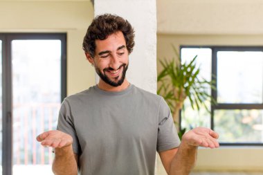 young adult crazy man with expressive pose at a modern house interior