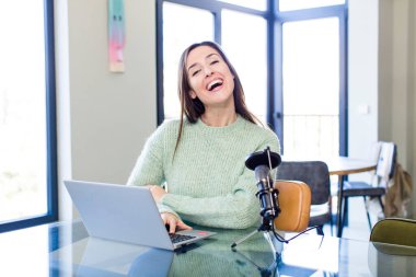 young pretty woman looking happy and pleasantly surprised. influencer concept