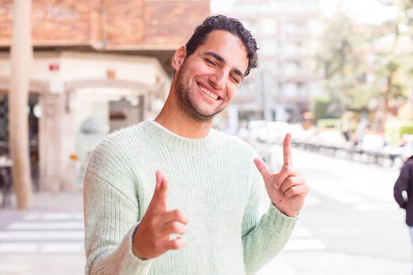Young Hispanic Man Feeling Happy Cool Satisfied Relaxed Successful Pointing — Stock Photo, Image