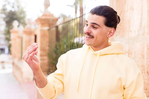 stock image young cool man feeling happy, successful and confident, facing a challenge and saying bring it on! or welcoming you