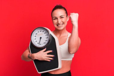 young pretty woman with a scale. diet and fitness concept