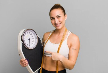 young pretty woman with a scale. diet and fitness concept