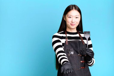 pretty asian woman smiling happily with friendly and  offering and showing a concept. barber concept