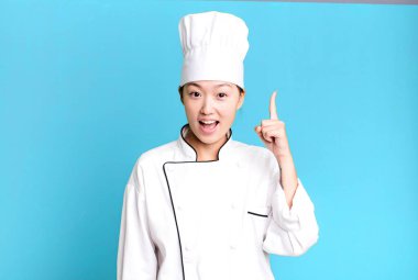 pretty asian woman feeling like a happy and excited genius after realizing an idea. restaurant chef concept