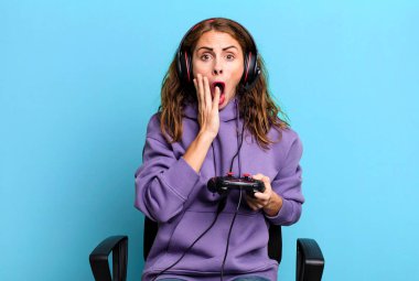 hispanic pretty woman feeling shocked and scared. gamer concept