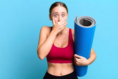 caucasian pretty woman covering mouth with hands with a shocked. fitness and yoga concept