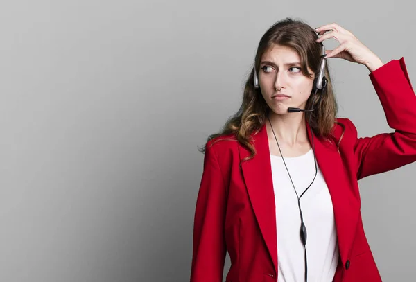 Stock image caucasian pretty woman smiling happily and daydreaming or doubting. telemarketer agent concept