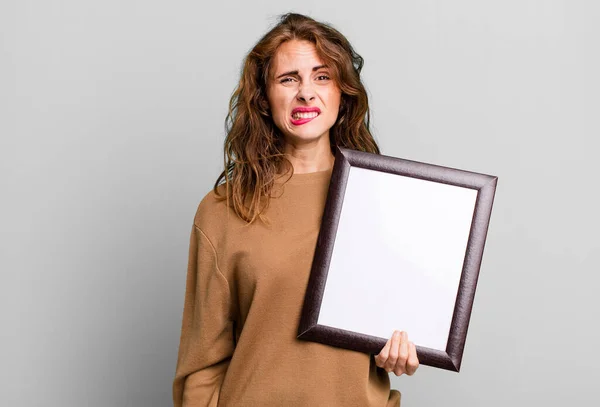 Hispanic Pretty Woman Looking Puzzled Confused Empty Blank Frame — Foto de Stock