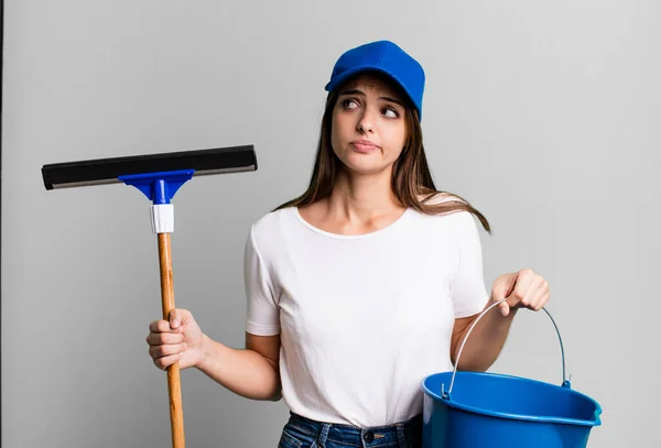 Young Pretty Woman Housekeeper Cleaning Windows — стоковое фото