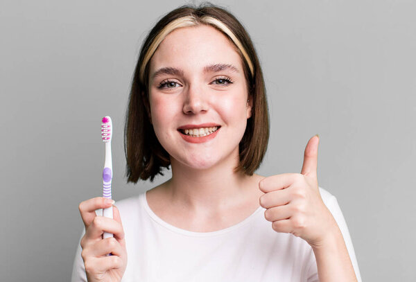young pretty woman using a toothbrush