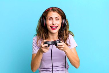 hispanic pretty young woman playing with headphones and a control. gamer concept