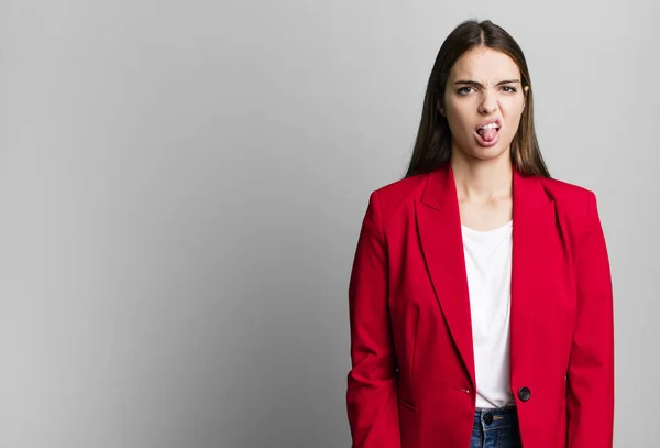 young pretty woman feeling disgusted and irritated and tongue out. businesswoman concept