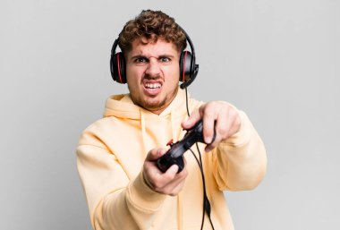 young adult caucasian man with headset and a controller. gamer concept