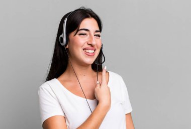 smiling cheerfully, feeling happy and pointing to the side. telemarketer concept