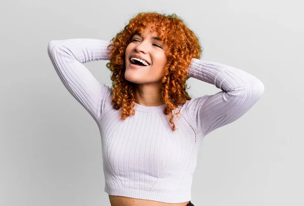 stock image redhair pretty woman smiling and feeling relaxed, satisfied and carefree, laughing positively and chilling