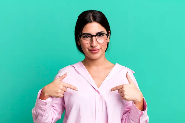 Stock image looking proud, positive and casual pointing to chest with both hands