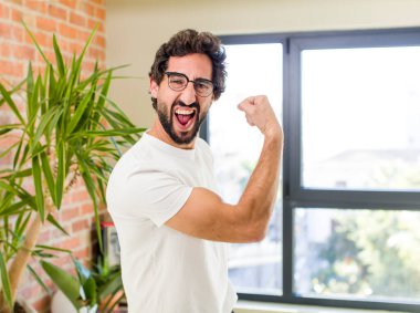 young adult crazy man with expressive pose at a modern house interior