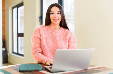 pretty young woman with a laptop on a desk  at home