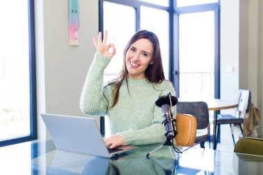 young pretty woman feeling happy, showing approval with okay gesture. influencer concept