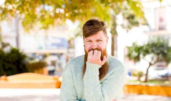 stock image red hair bearded man feeling terrified, in horror and panic