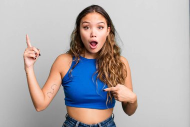 Genç ve güzel bir kadın gururlu ve şaşırmış hissediyor. Kendine güvenerek kendini bir numara gibi hissediyor.