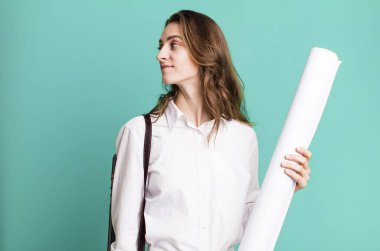 young pretty woman on profile view thinking, imagining or daydreaming. architect concept