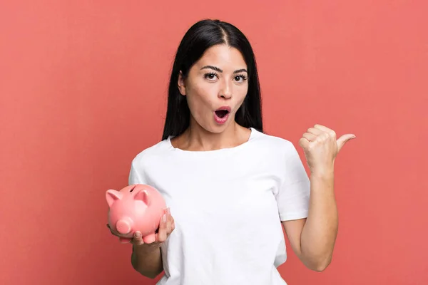 Hispanic Pretty Woman Looking Astonished Disbelief Piggy Bank — Foto Stock