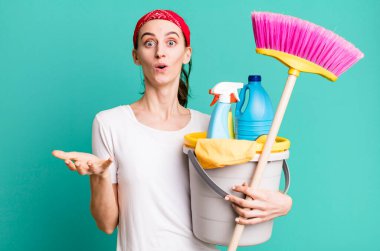 young pretty woman feeling extremely shocked and surprised. housekeeper concept