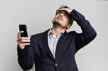 young adult caucasian businessman with a smartphone