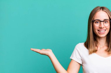 pretty blonde woman presenting a concept with a copy space