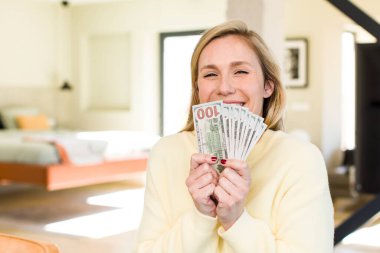 young adult pretty blonde woman with banknotes