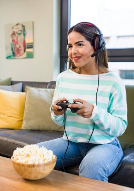 pretty latin woman playing with headset and controller. gamer concept