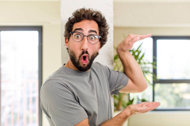 young adult crazy man with expressive pose at a modern house interior