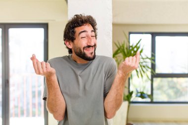 young adult crazy man with expressive pose at a modern house interior